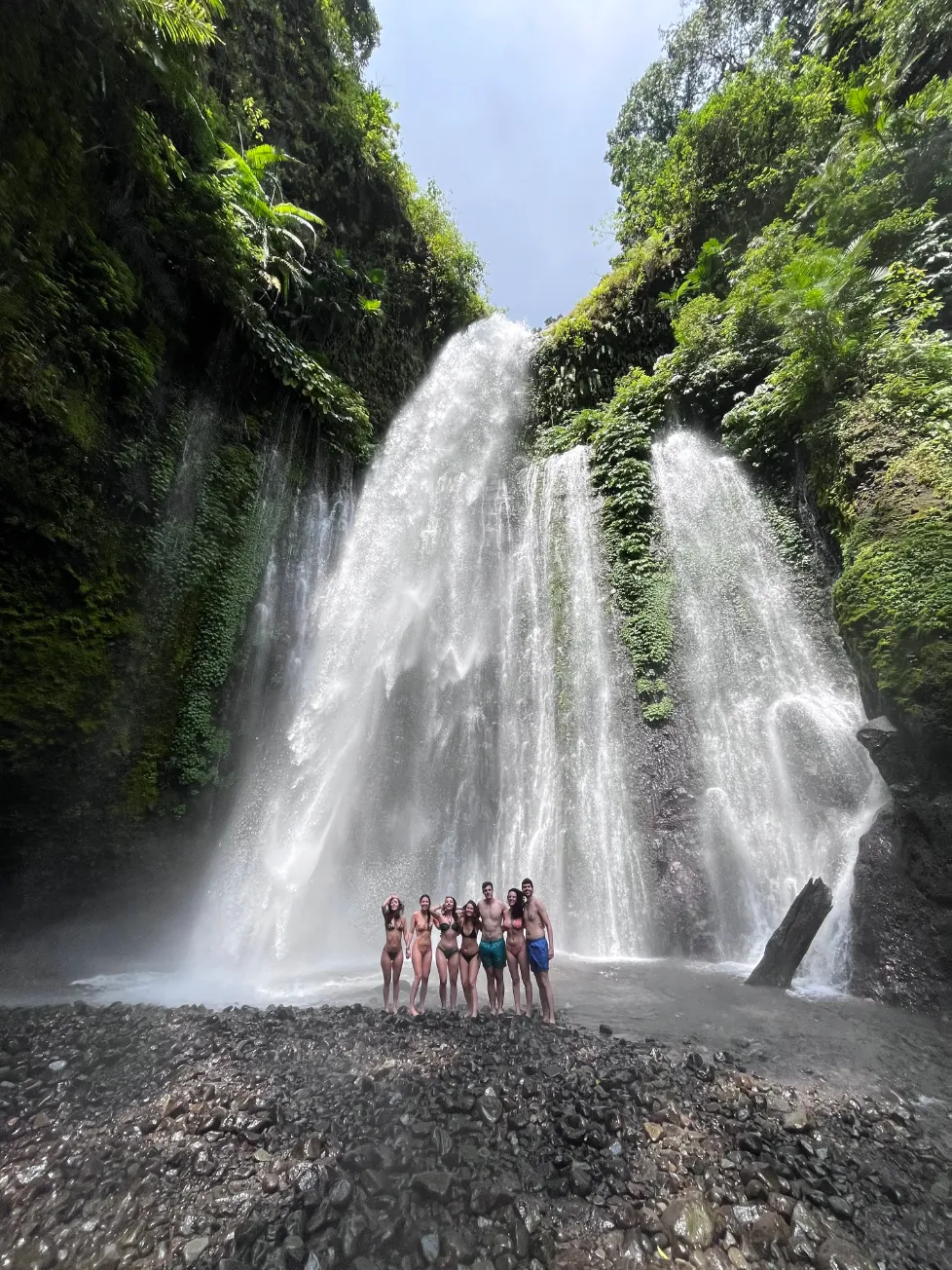 Majestic waterfall in the jungle with misty spray and lush green surroundings