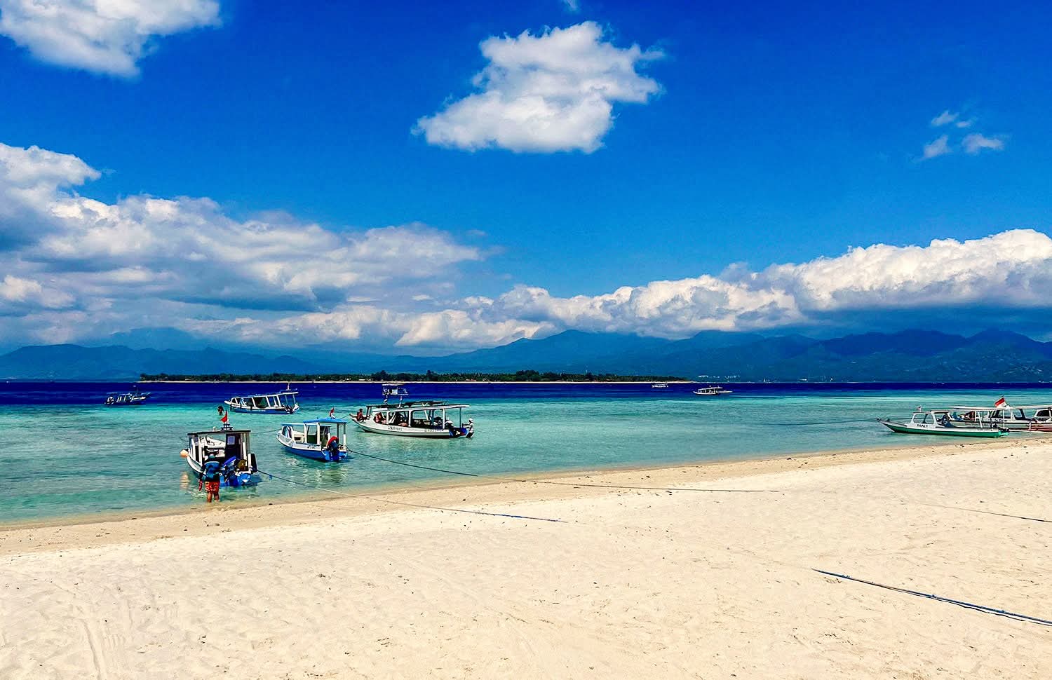 Three beautiful tropical islands with white sandy beaches and palm trees