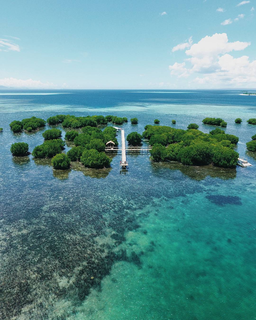 Pristine beaches and coral reefs around Gili Kondo